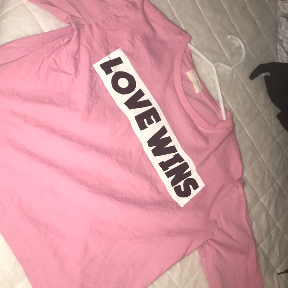 pink shirt with "love wins"